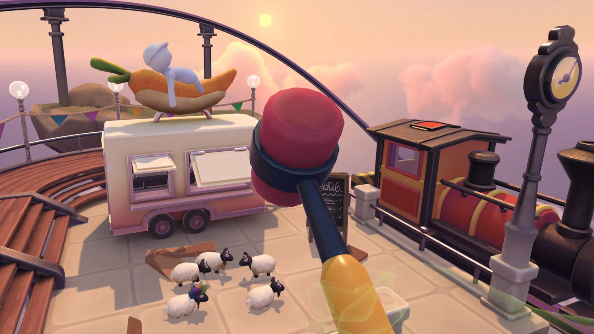 First-person VR view of a red mallet above a food truck, a banana boat with a white figure, a toy train and a cluster of tiny sheep on a sunset platform