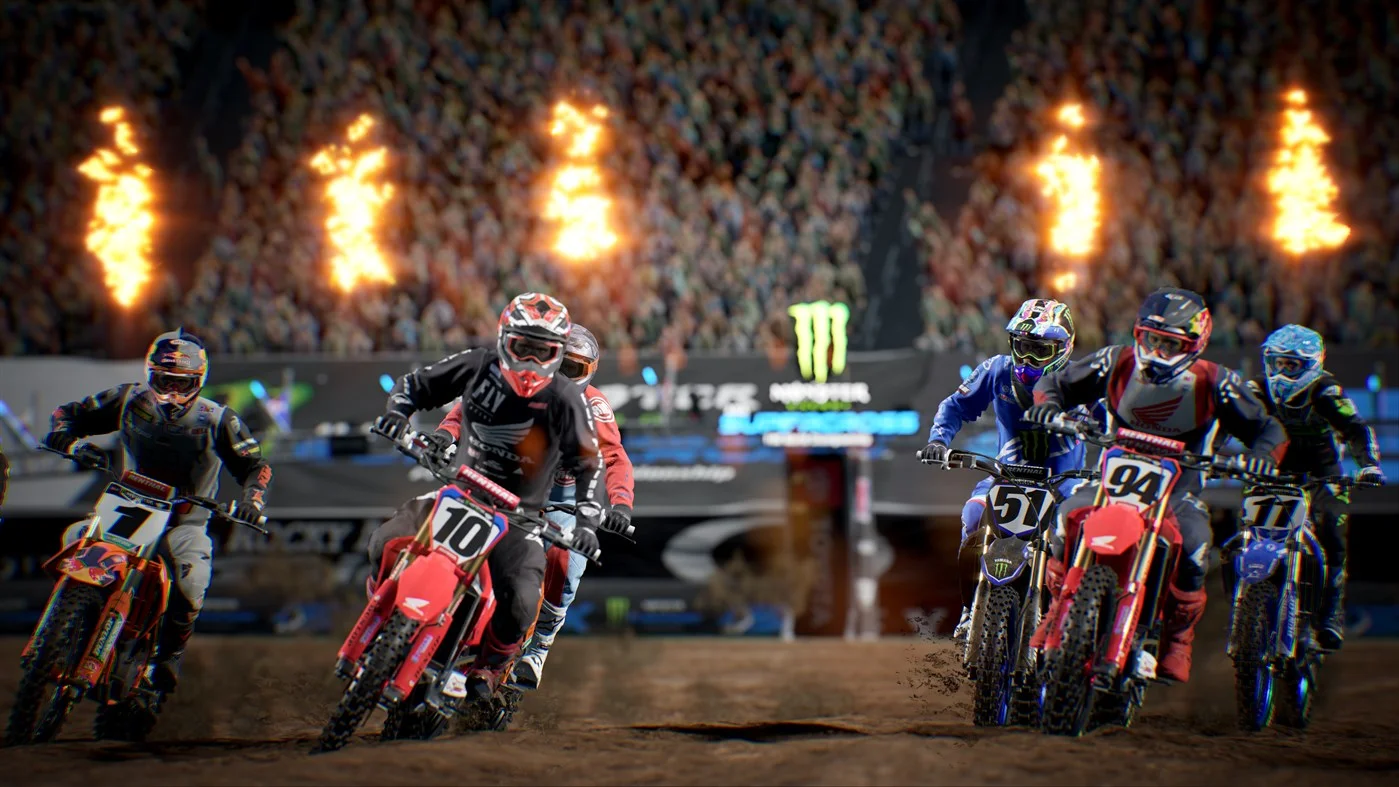 A packed stadium start with Honda 10 and 94 charging under flame cannons
