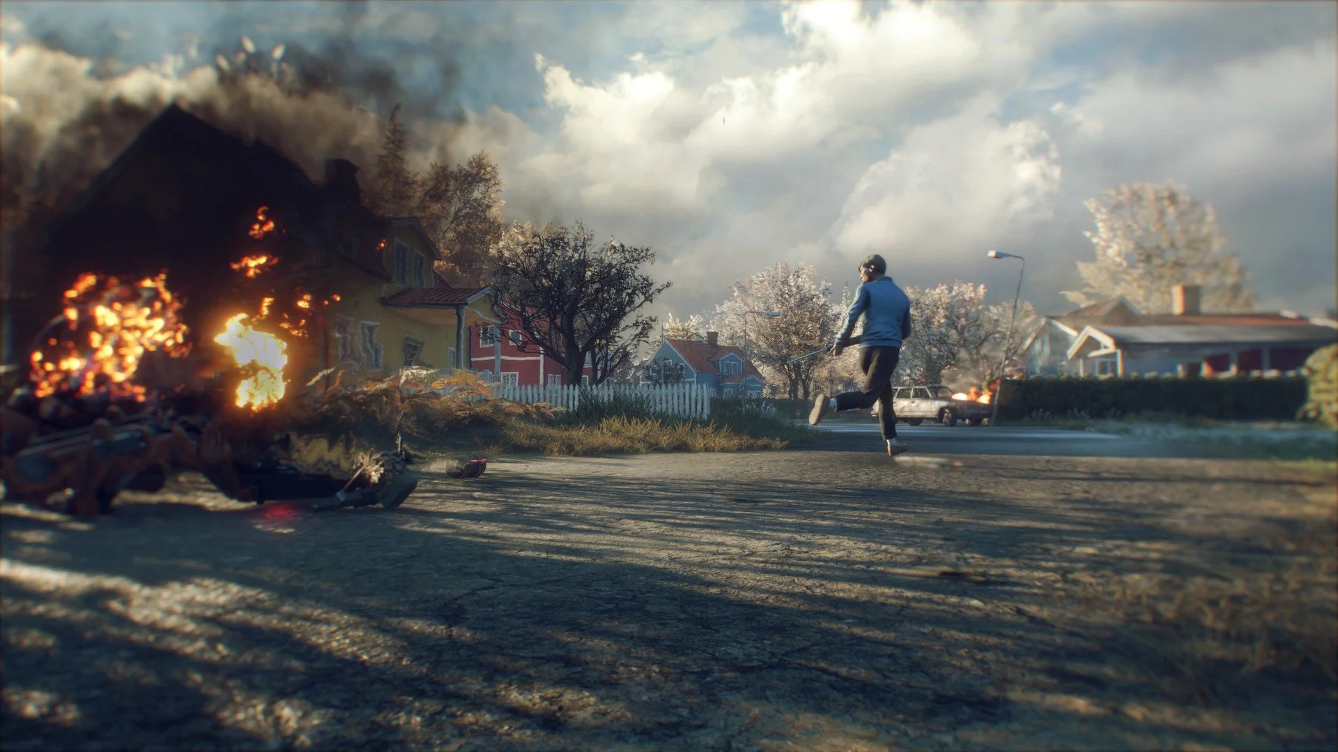 Survivor running a Swedish village street past a burning wreck