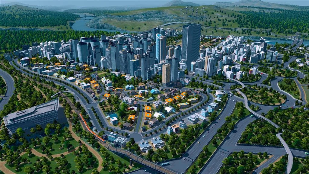 Downtown core ringed by orange industrial sheds, looping highways, and forested hills