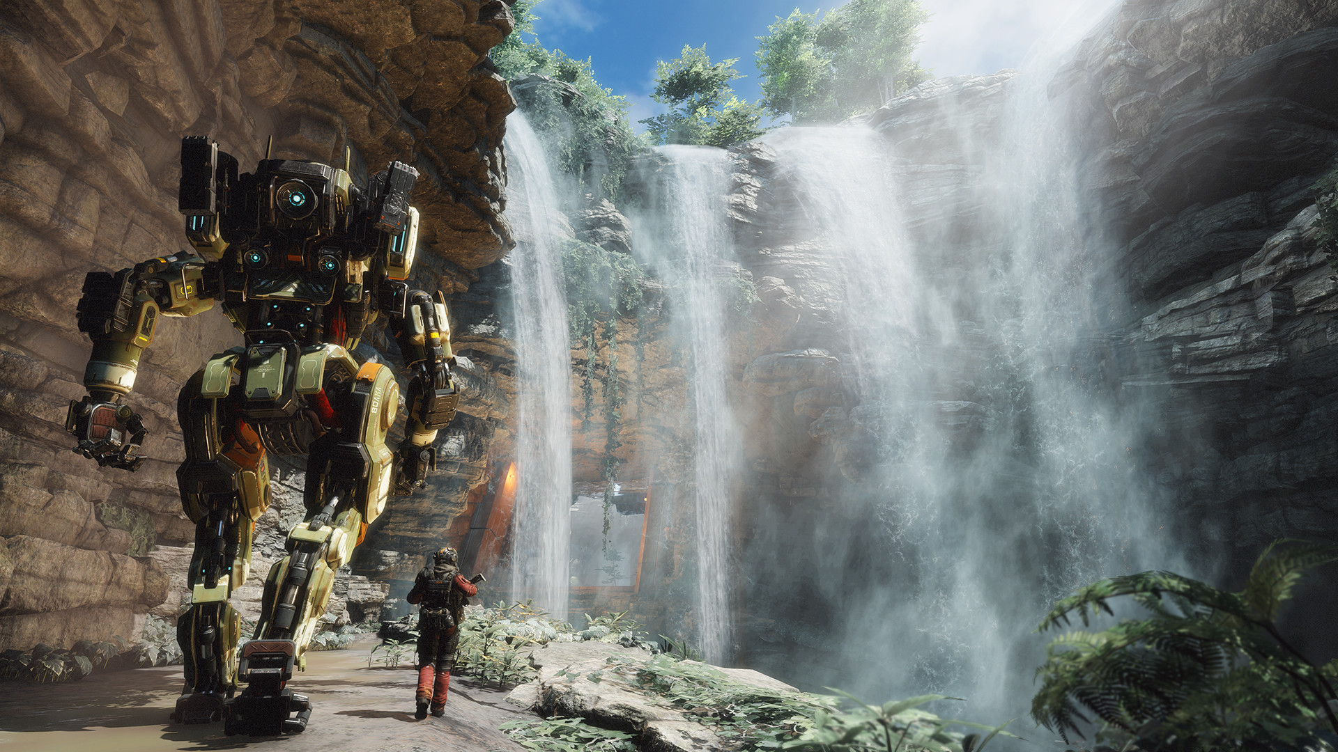 Pilot walks with a titan beside jungle waterfalls