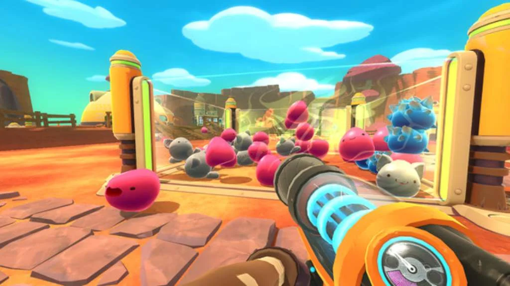 First-person vacpack at a desert corral of pink, grey and blue slimes between yellow gate posts