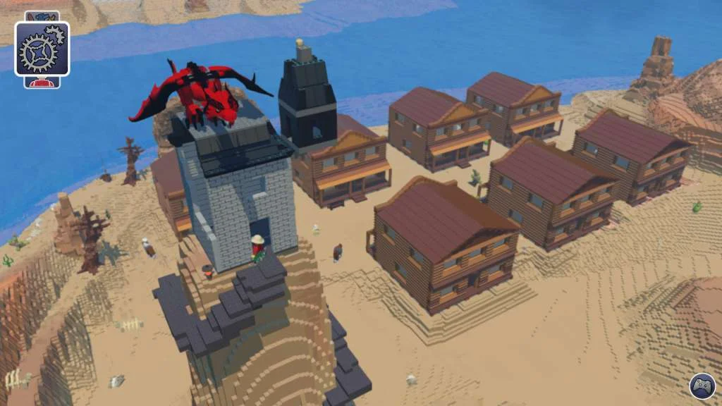 Red brick dragon perched on a grey tower above a sandy town of brown-roofed houses beside blue water