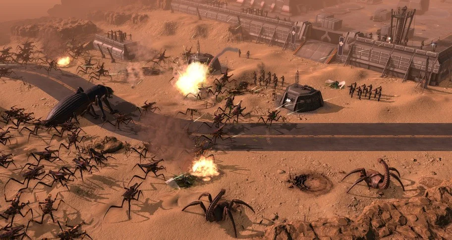 Daytime desert road overrun by a huge beetle-like bug and an Arachnid swarm attacking a bunker line