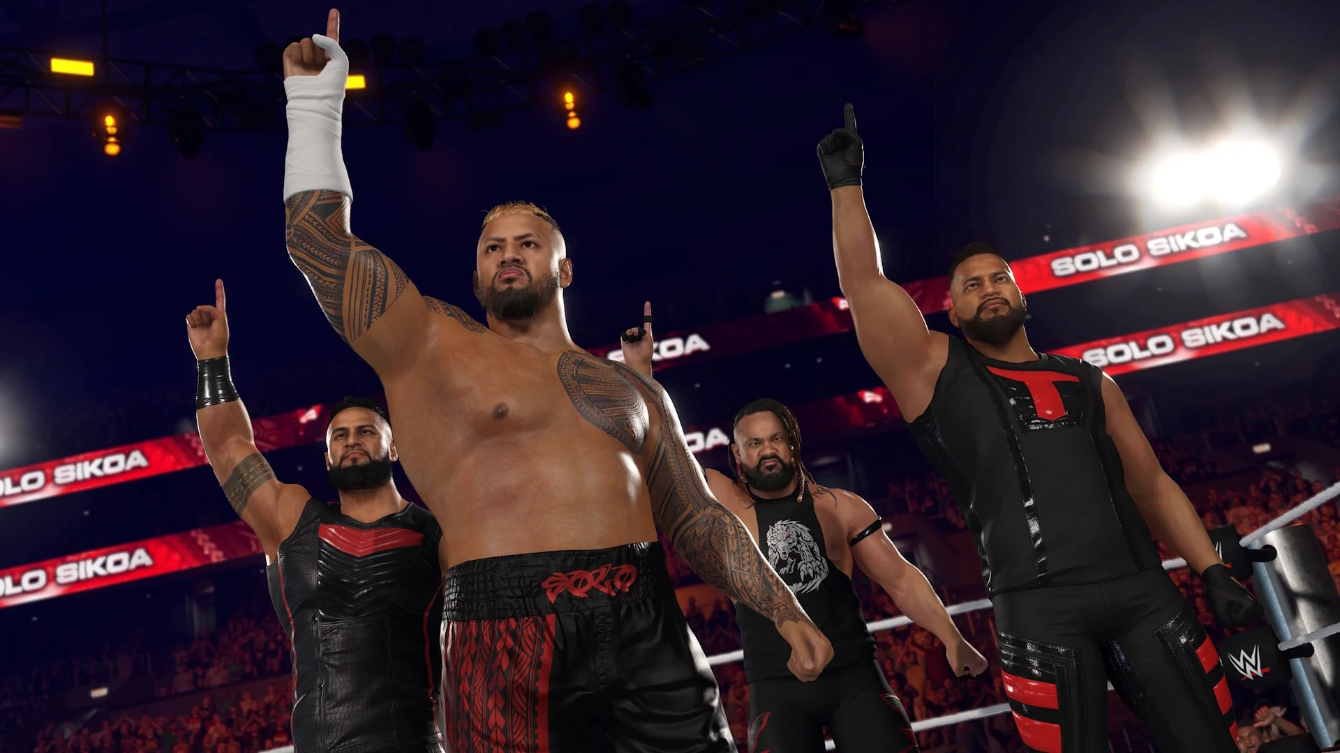 Solo Sikoa and three Bloodline members raise their fingers in the ring under red Solo Sikoa banners