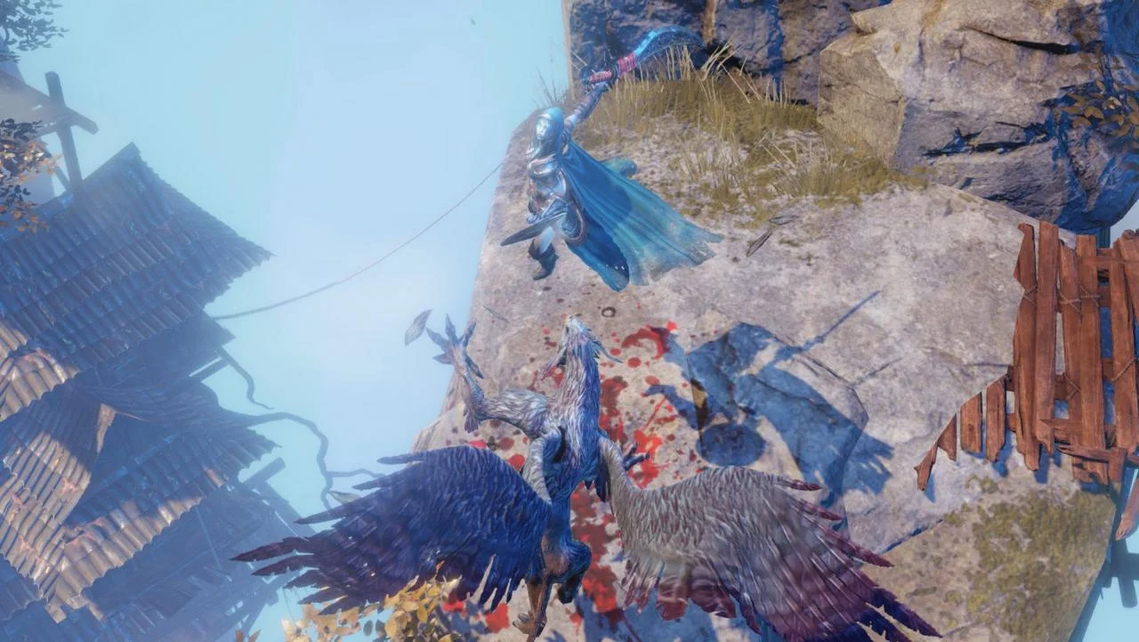 Cliff edge: blue-caped scythe fighter above a grey griffin with blood on the rock and a hut roof below