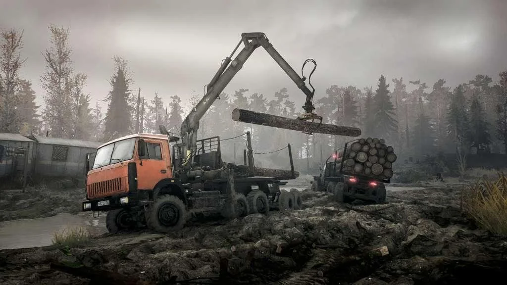 Orange crane truck lifting a log toward a loaded timber truck on a grey logging plot