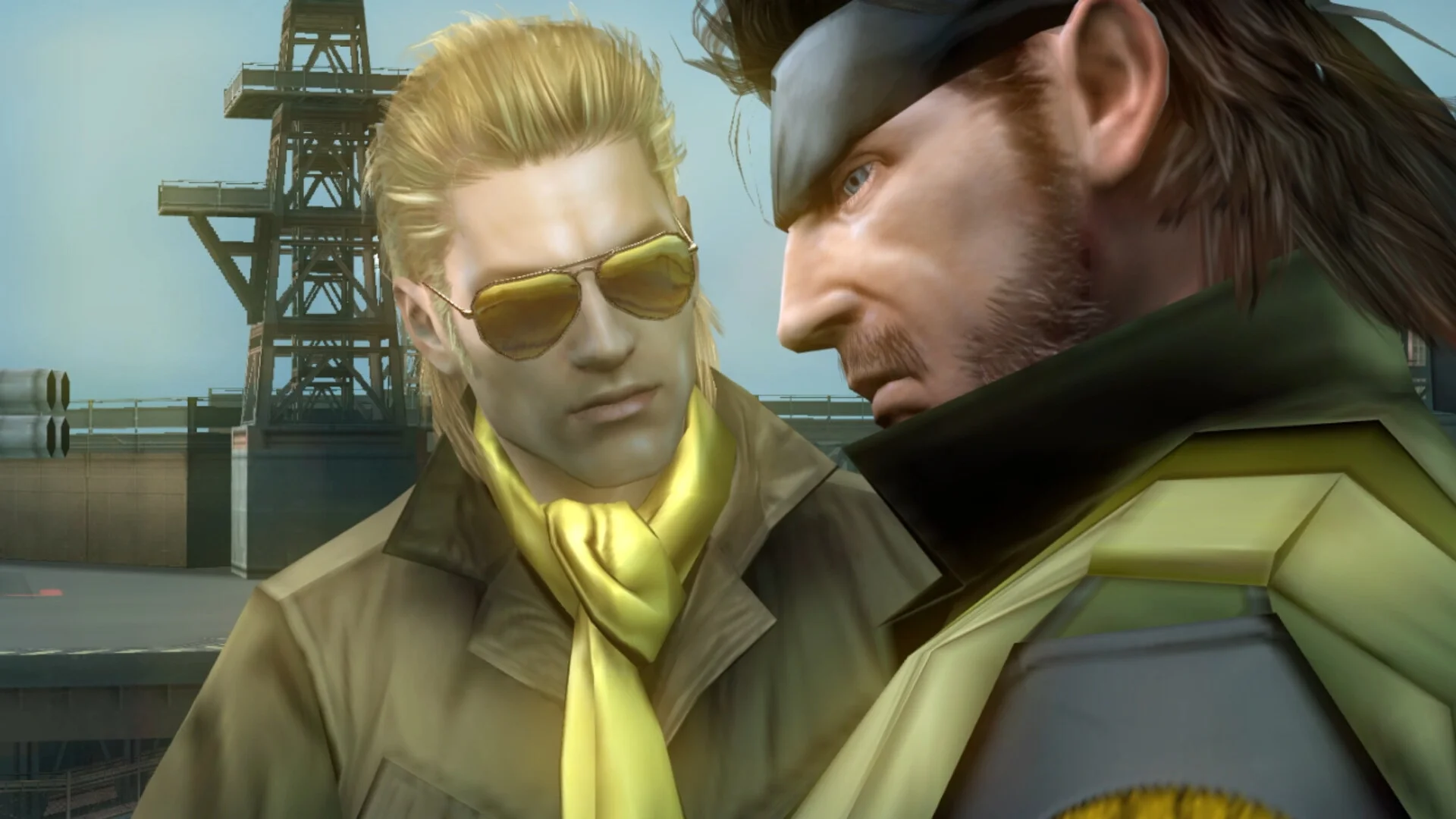 Kazuhira Miller in sunglasses and a yellow scarf facing Big Boss in a yellow-collared sneaking suit, radio tower behind