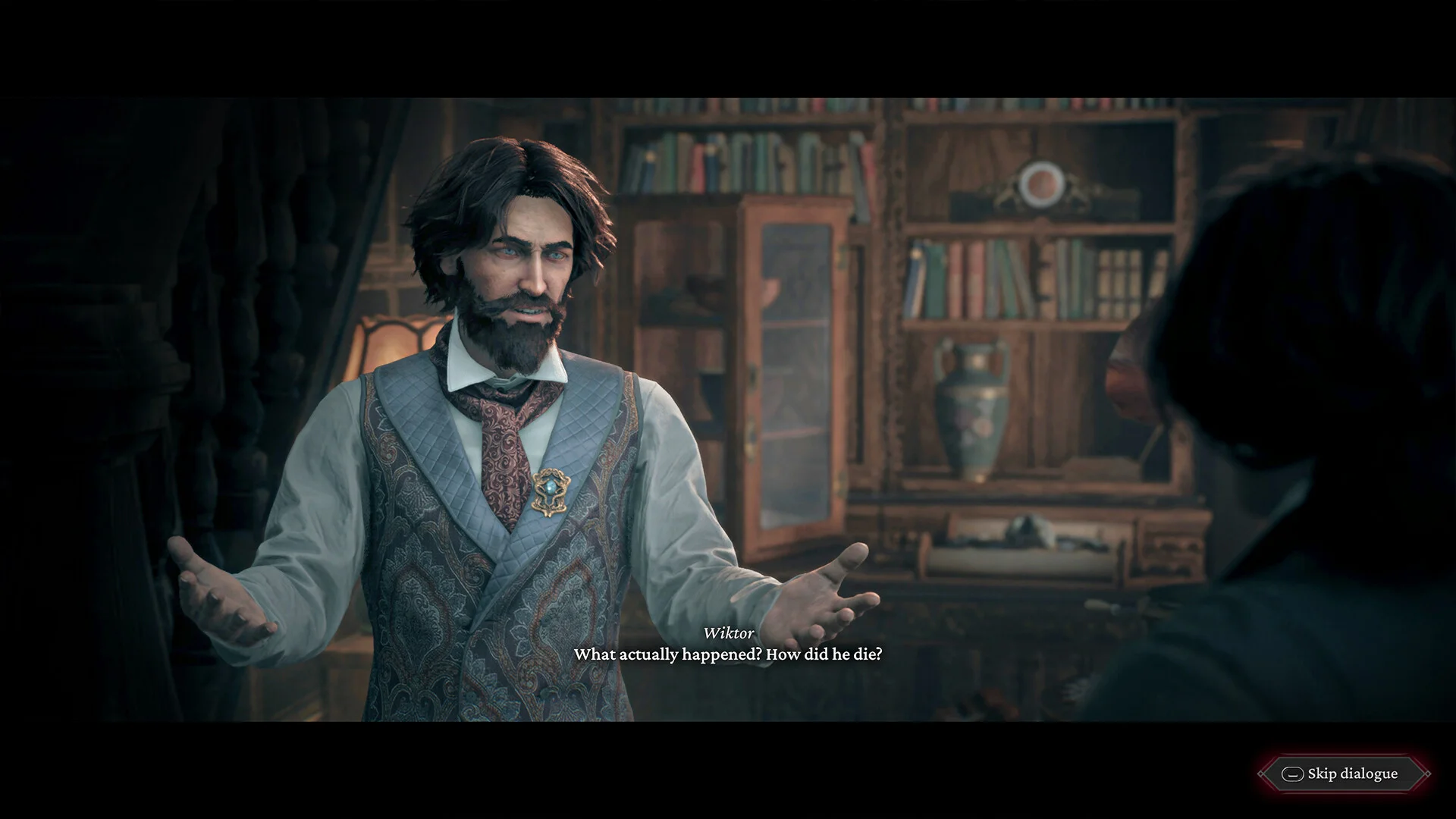 Book-lined study: paisley waistcoat, open hands, subtitle asking Wiktor what actually happened