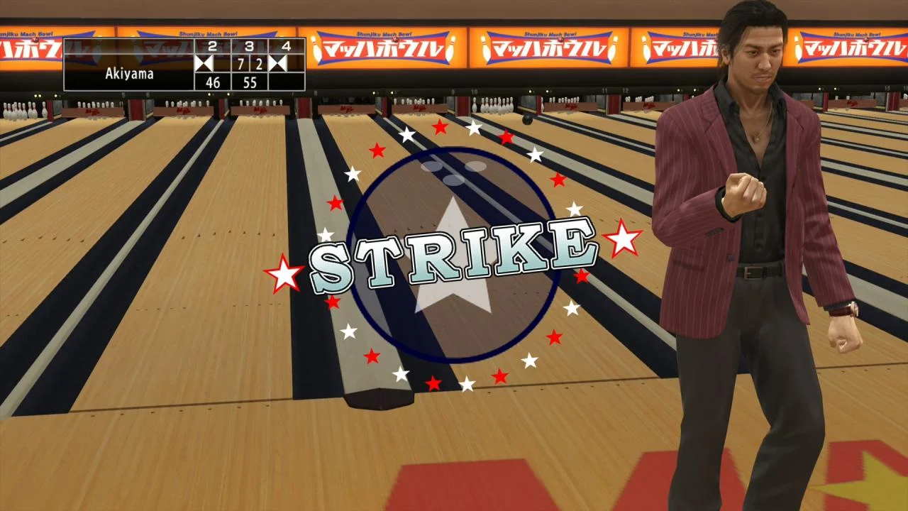 Akiyama bowls a strike while a crowd watches from the lanes