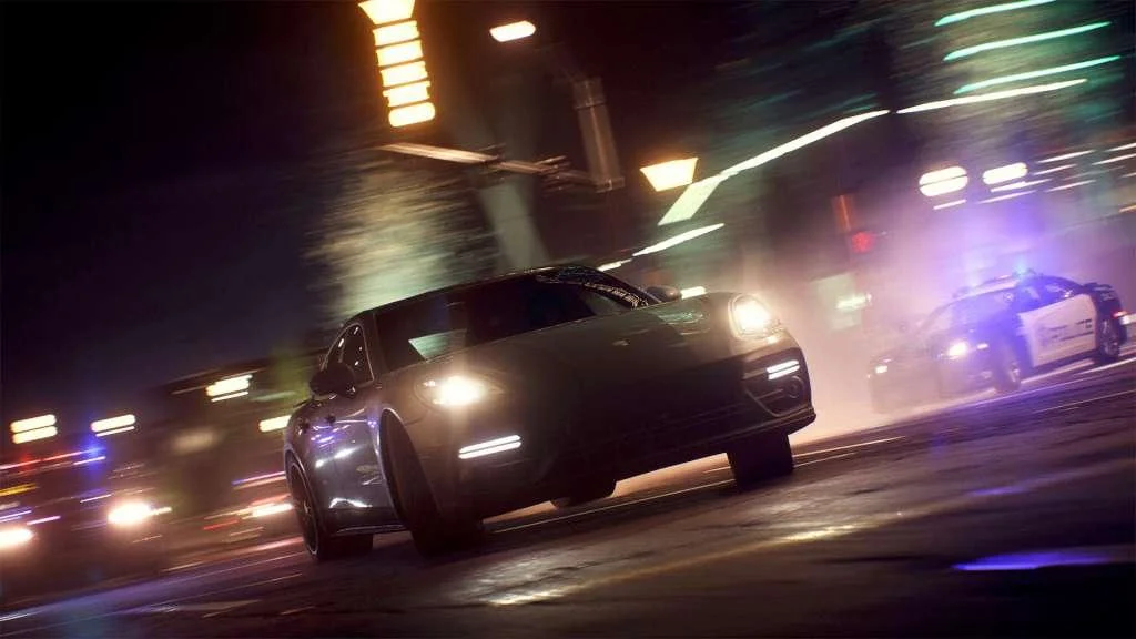 Close view of a dark car in neon city light.