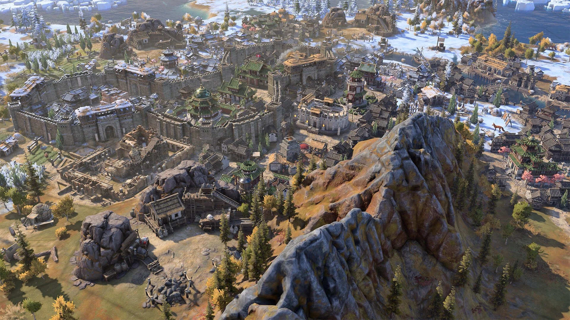 Snow-dusted walled city with pagoda roofs, a stone keep, and autumn trees on a rocky slope