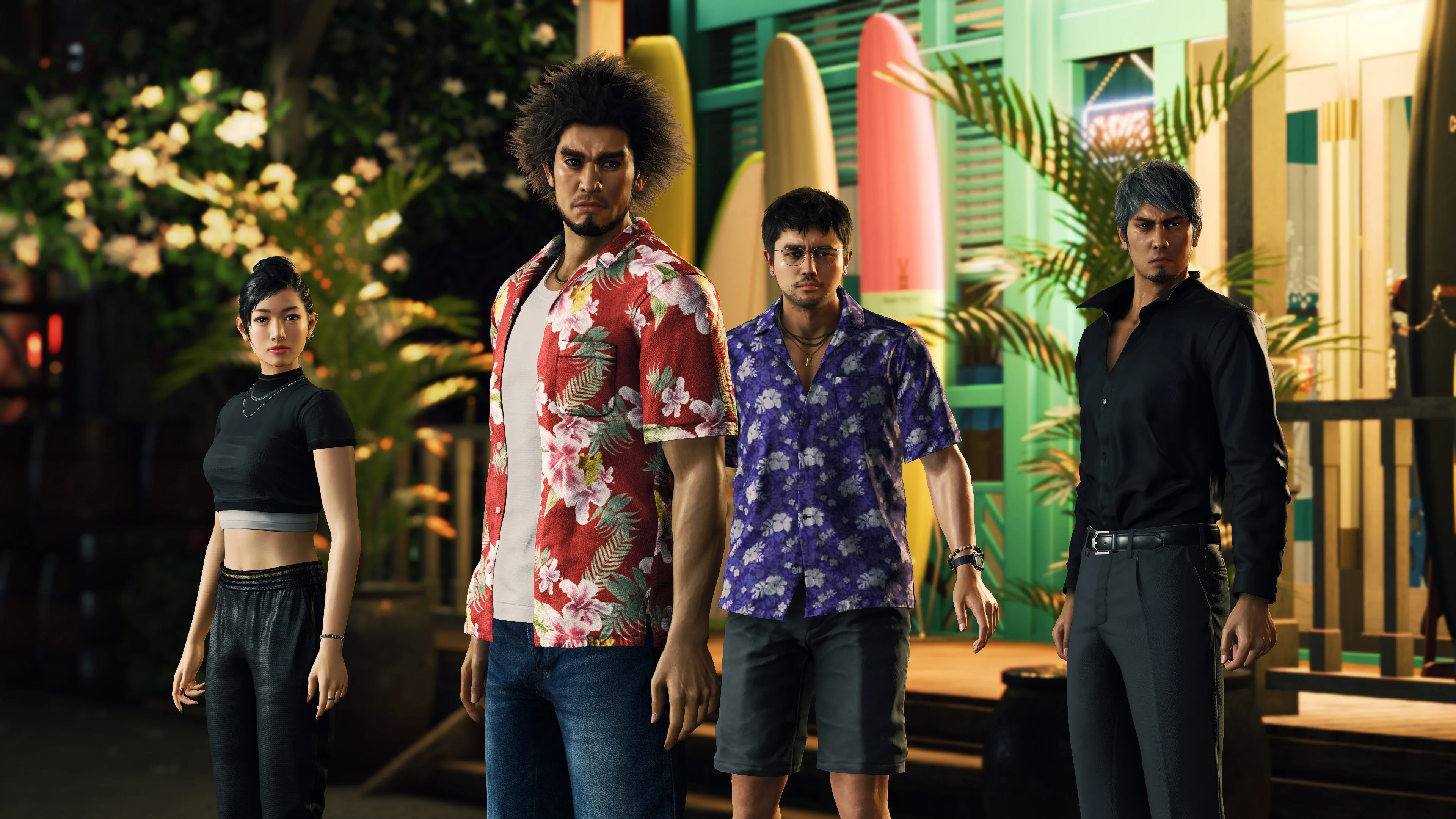 Four-person party standing at night in front of surfboards and a green Hawaii shop