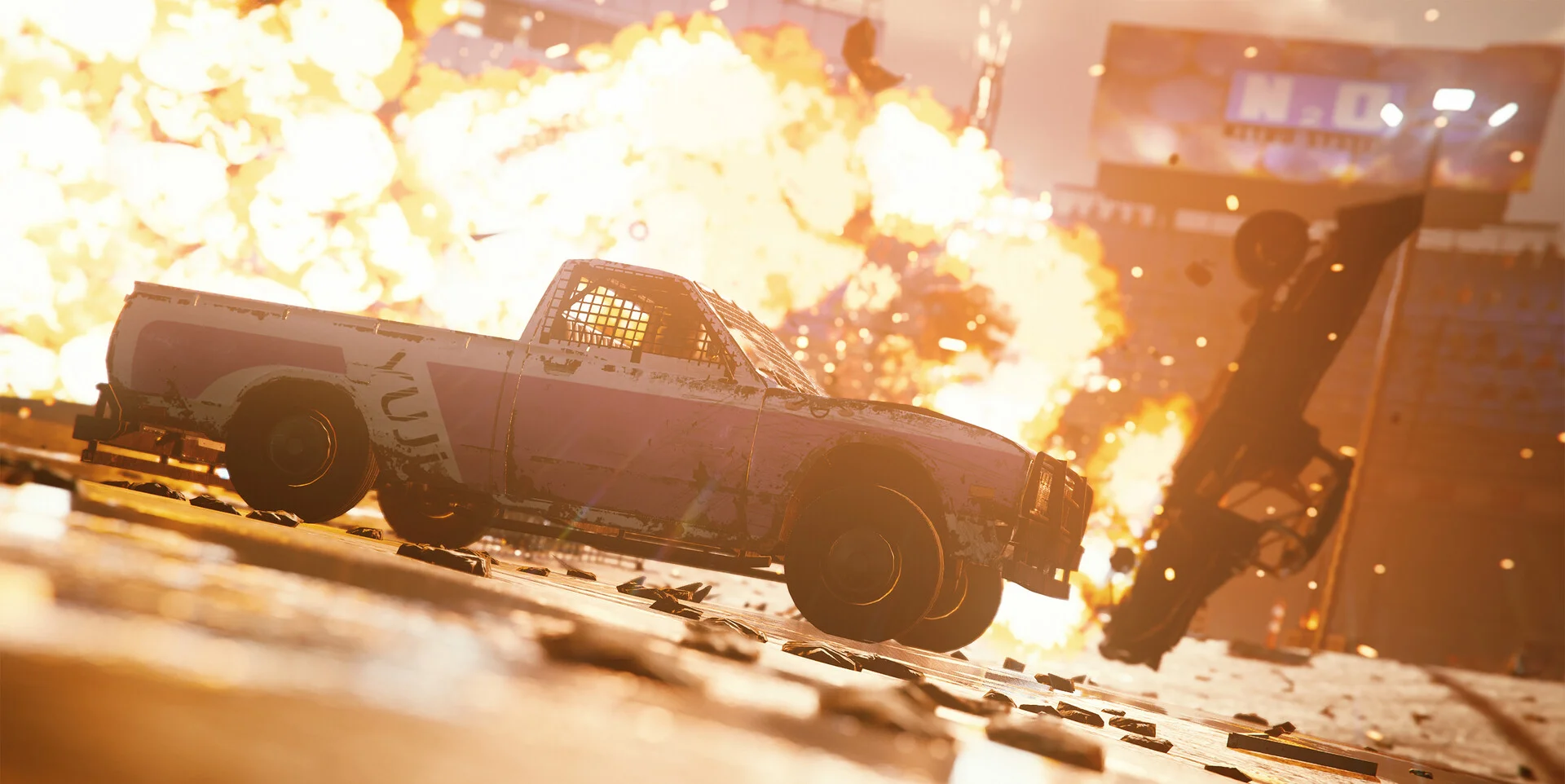 White cage-window pickup airborne in a fireball, another wreck flipping, wet asphalt, N-D billboard