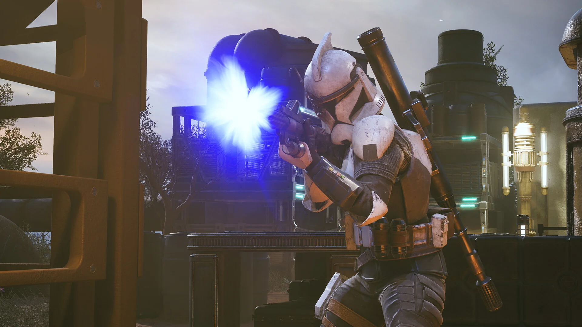 A clone trooper firing a blue blaster burst in an industrial yard, launcher on his back