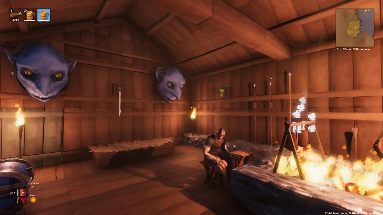 Timber hall interior, two blue troll heads on the wall, a Viking at a stool by a fire pit, Forest map, Shelter