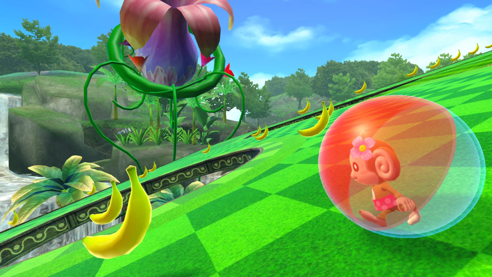 The monkey rolls up a bright green slope dotted with bananas.