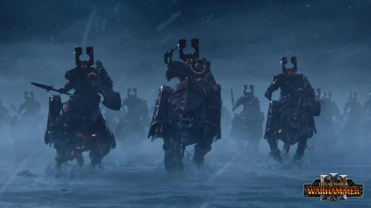 Three armored riders with tall crests charge through snow toward the viewer, a larger force behind them