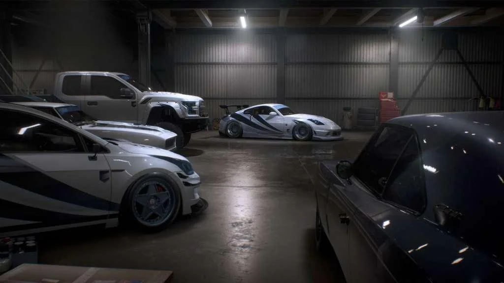 Garage lineup of customized cars under neon lights.