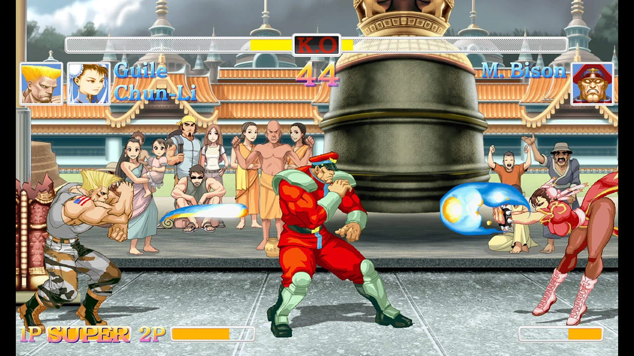 Ken and another fighter clash in a stone arena with spectators.