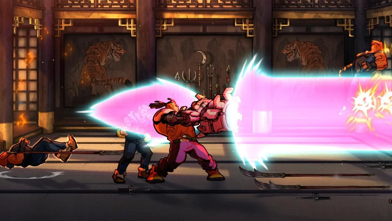 Dojo with tiger screens where a fighter fires a huge pink energy blast from a mechanical arm