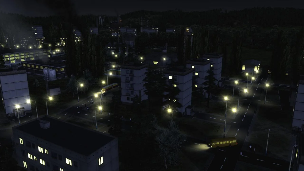 Night housing estate, lit windows and street lamps, yellow bus on the right and a red-and-yellow tram on the left