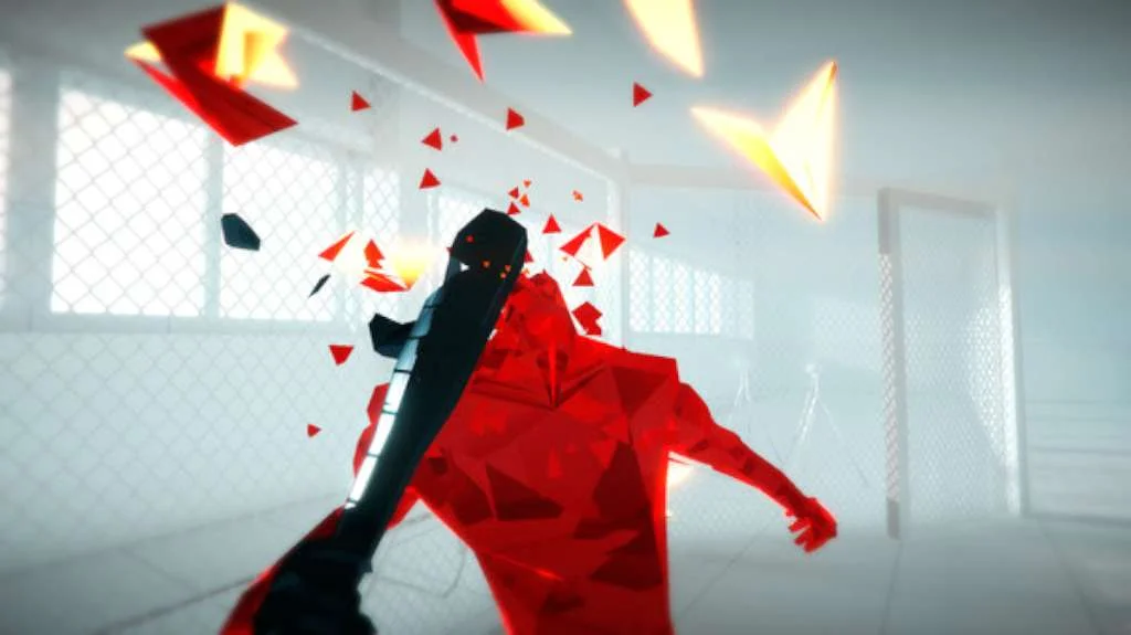 First-person bat swinging through a red crystal figure in a chain-fence room