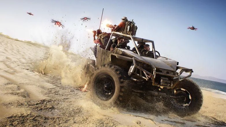 Open dune buggy firing on a beach while four drones fly overhead, sand spraying off the tires