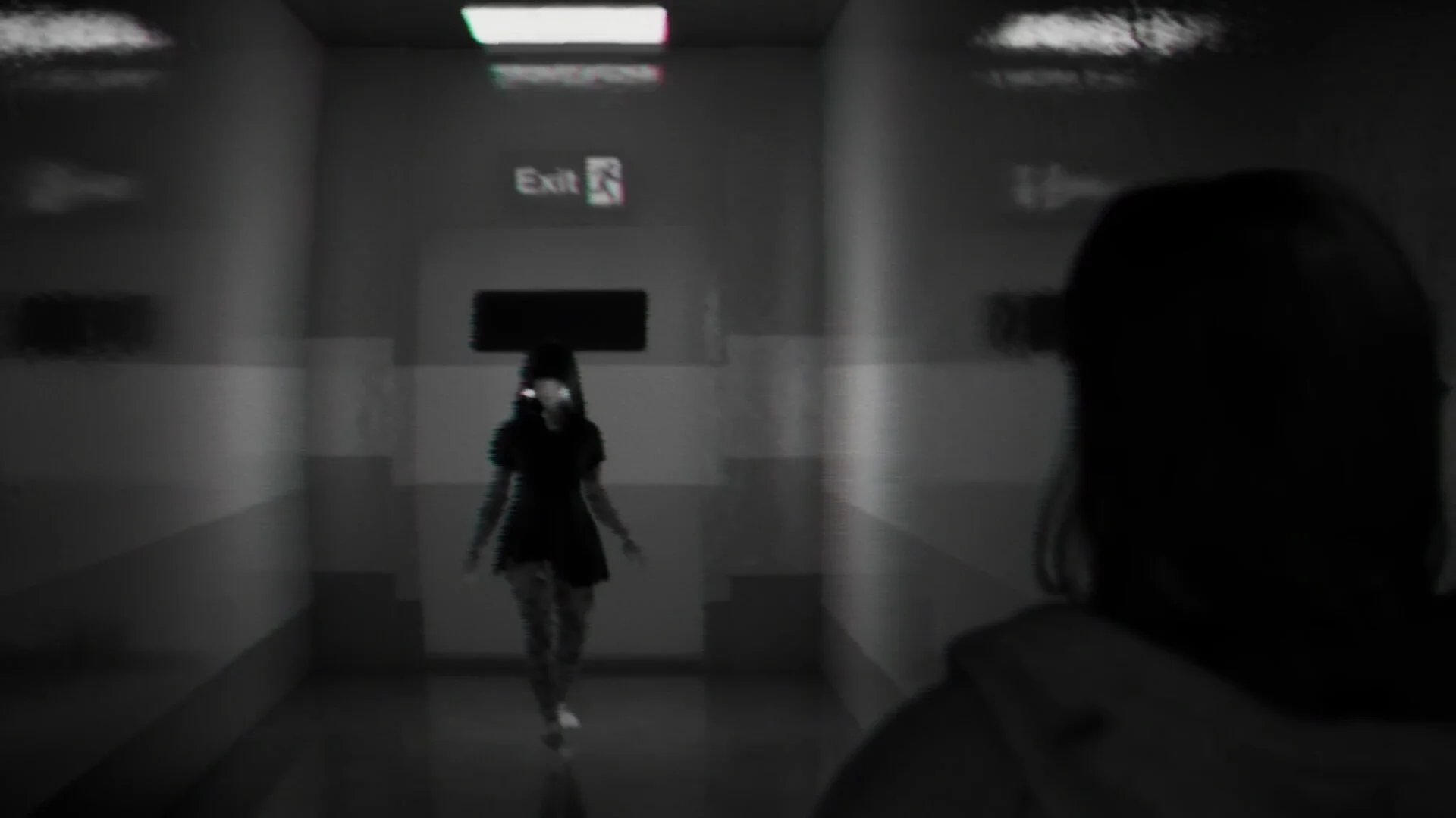 Grey Exit corridor: figure in black dress walking at camera, Exit sign above the door