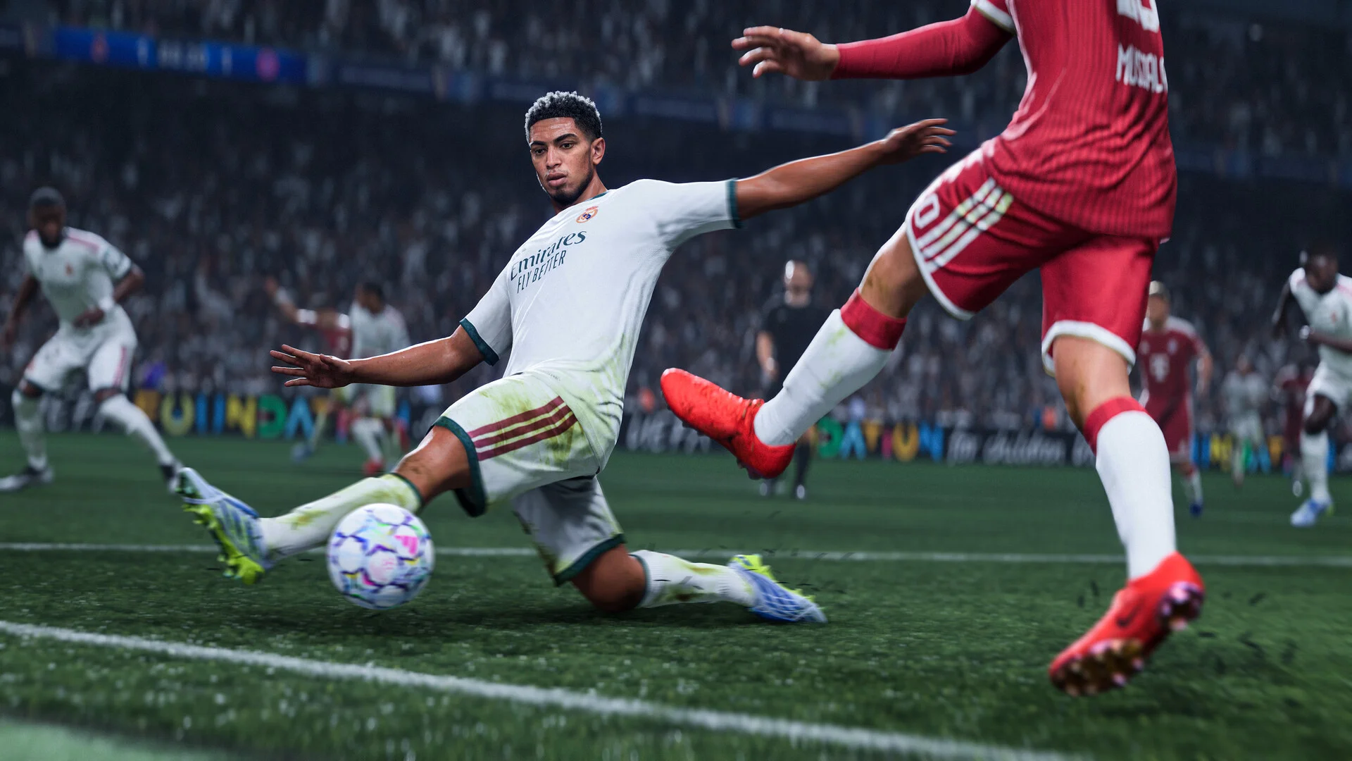 A player in a white kit slides for the ball as a red kit challenges