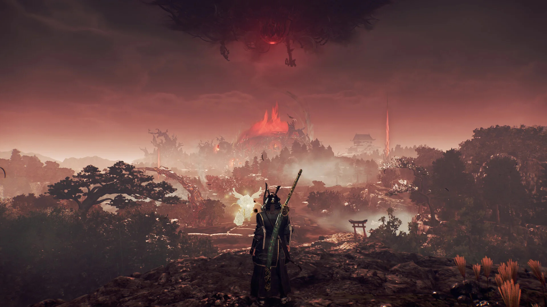 A figure with a sheathed sword looks over a red landscape toward a burning mass under a dark cloud