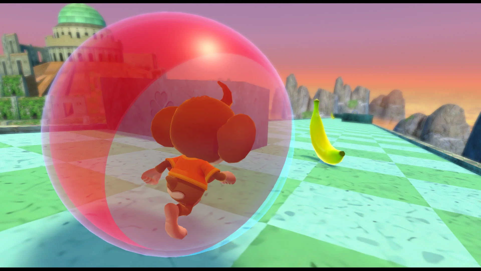 A monkey in a clear ball rolls along a rainbow path toward a pink palace.
