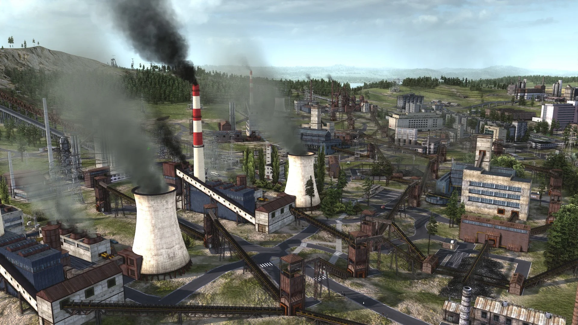 Power plant, two cooling towers and a striped chimney smoking, conveyor belts across an industrial town