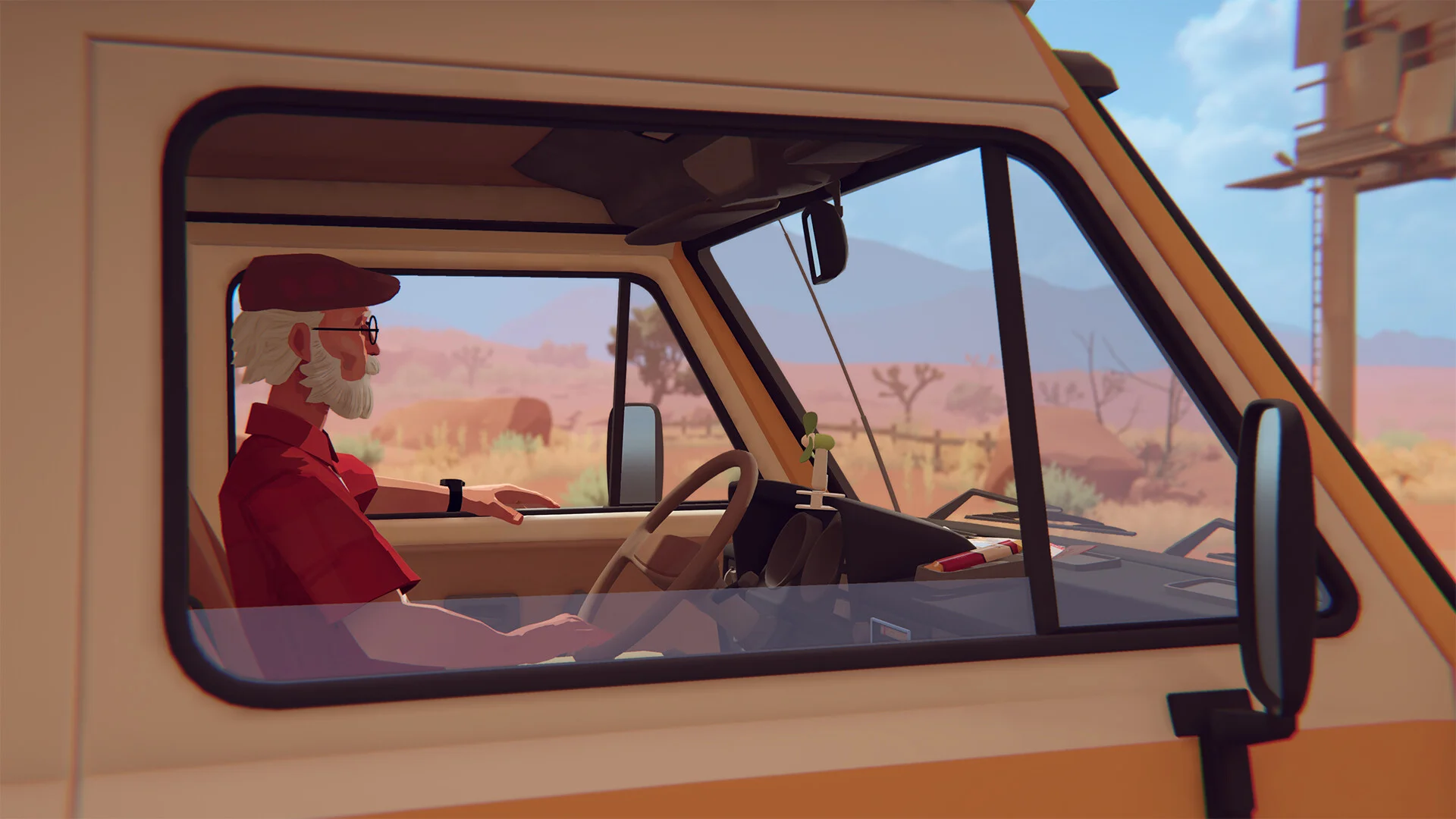 White-bearded driver in a red shirt and maroon cap sits at the wheel of a cream van facing a desert of Joshua trees
