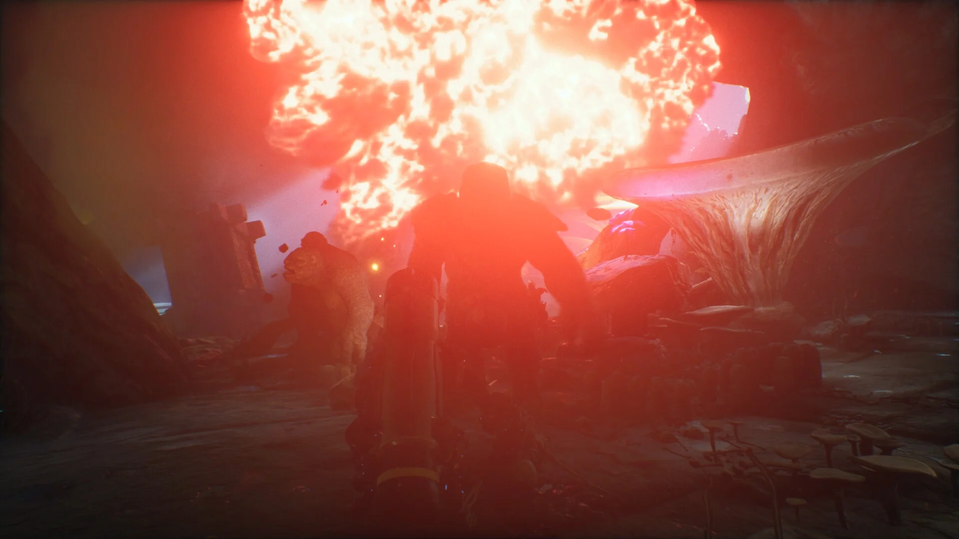 Silhouetted brute under a red fireball explosion in a mushroom cavern, another hulking figure to the left, gun in the foreground