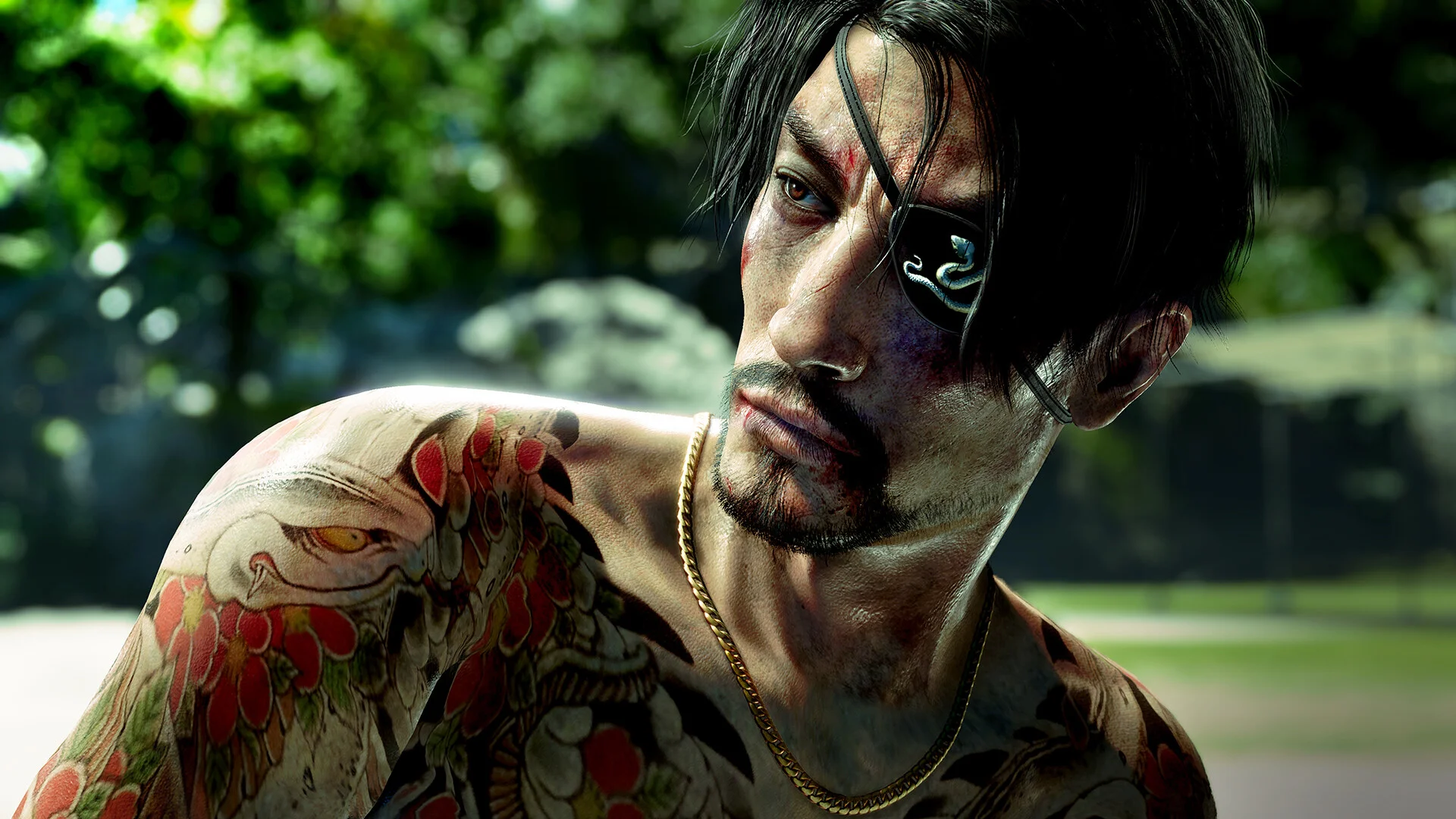 Close portrait of Goro Majima with an eyepatch, gold chain, and floral tattoos