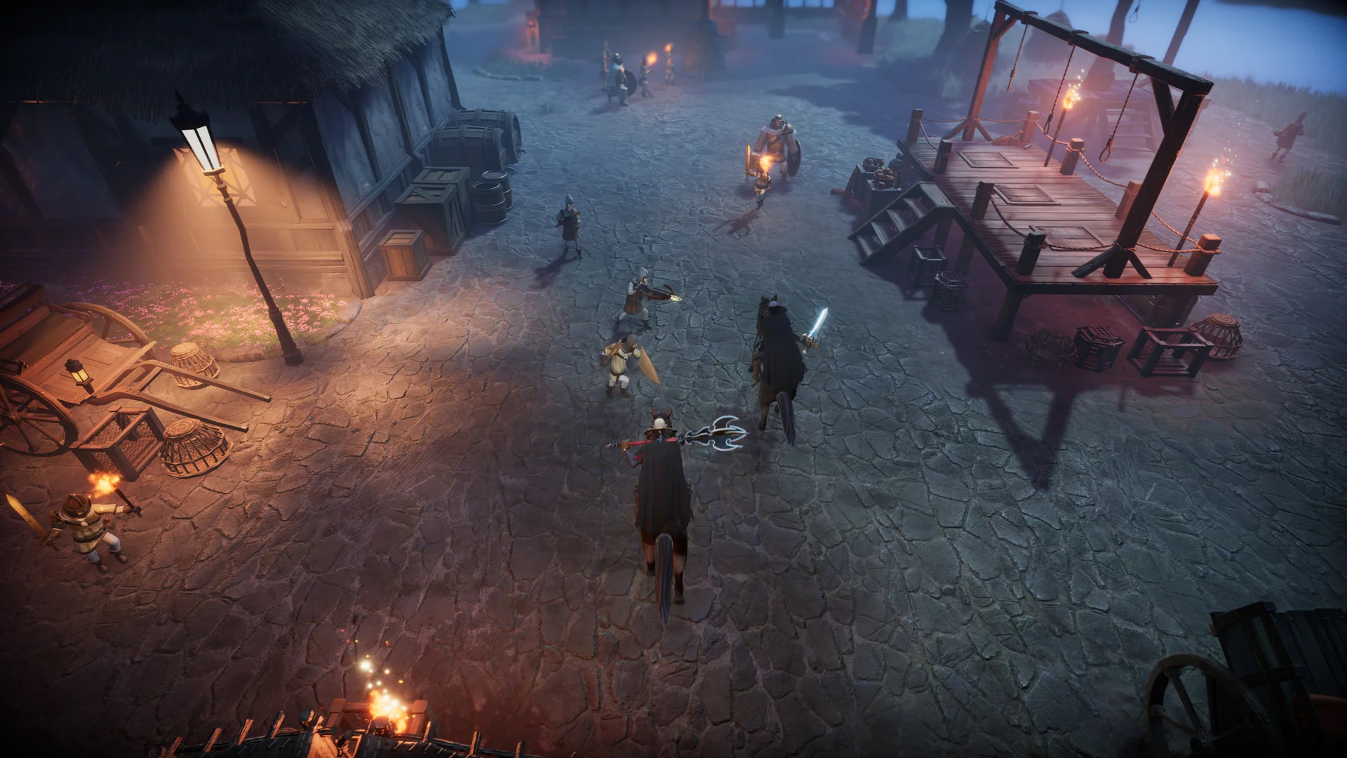A caped rider with a glowing weapon enters a torchlit village square