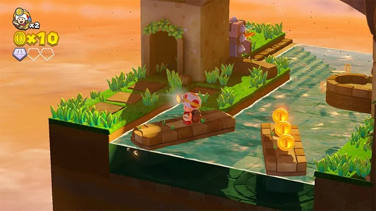 A riverside diorama with a mine cart, coins, and a small waterfall.
