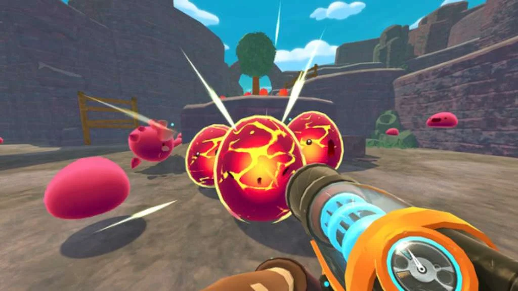 Vacpack aimed at three lava-cracked slimes in a stone canyon with pink slimes bouncing