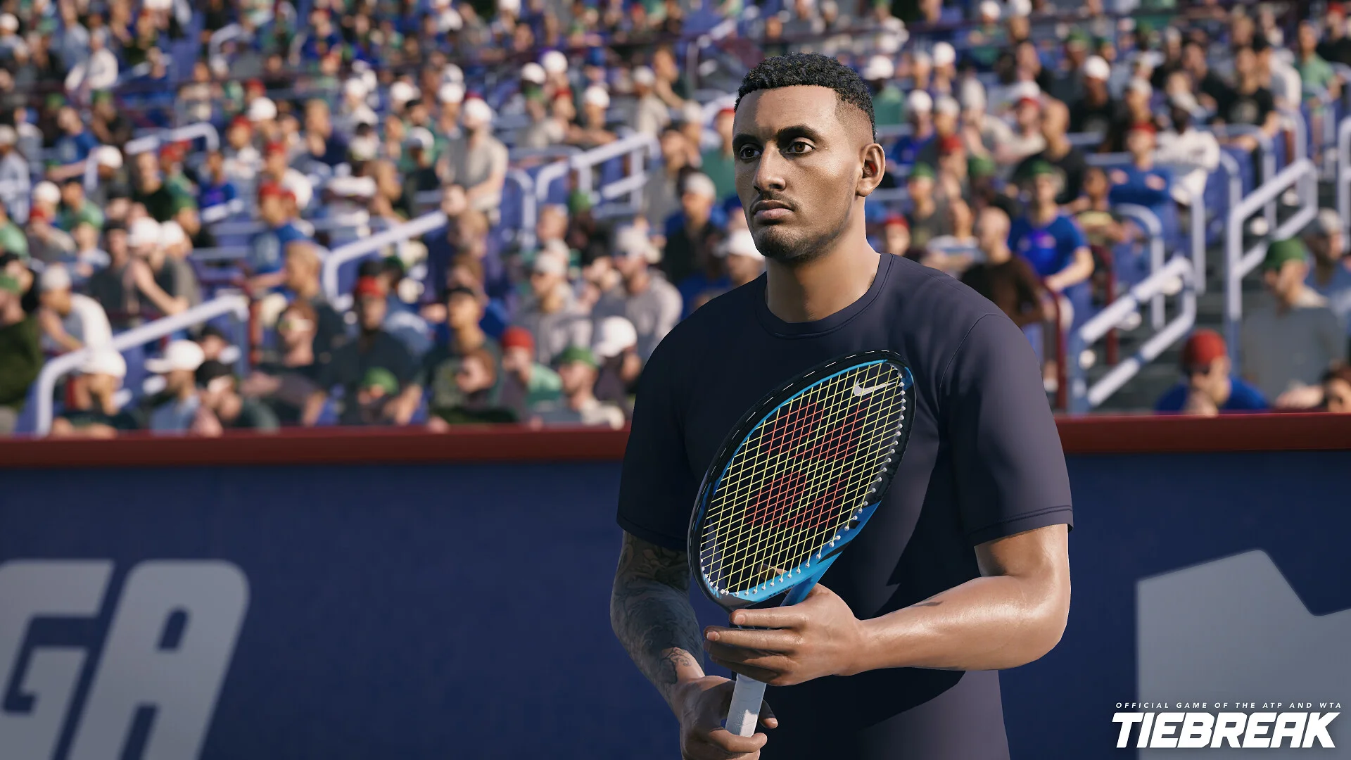 Nick Kyrgios in a navy shirt holding a blue racket against IGA padding and a packed crowd