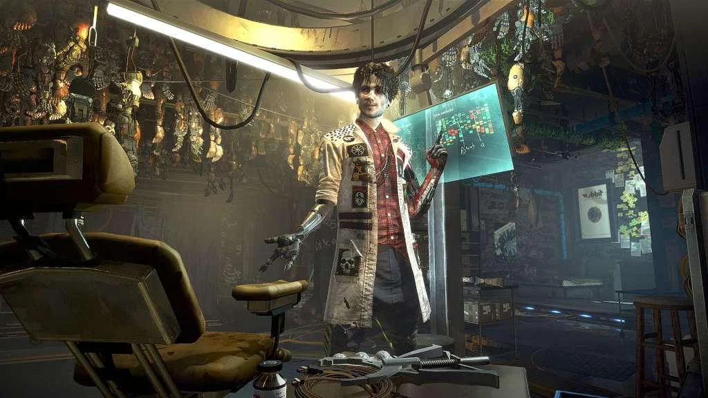 A man in a stained coat with a mechanical right arm standing in a cluttered clinic