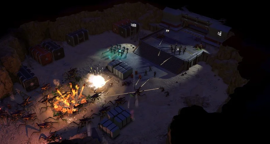 Night desert base with floodlights, crates and troopers on a stair platform while bugs explode at the left