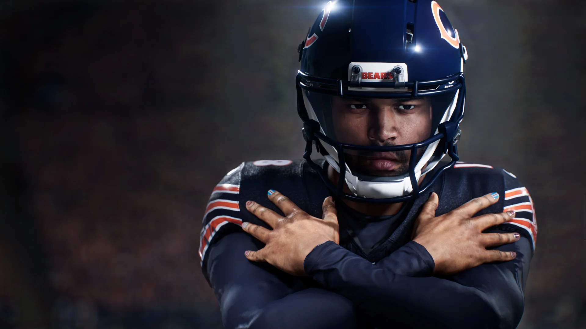 A helmeted athlete in a navy-and-orange kit crossing both arms on the chest