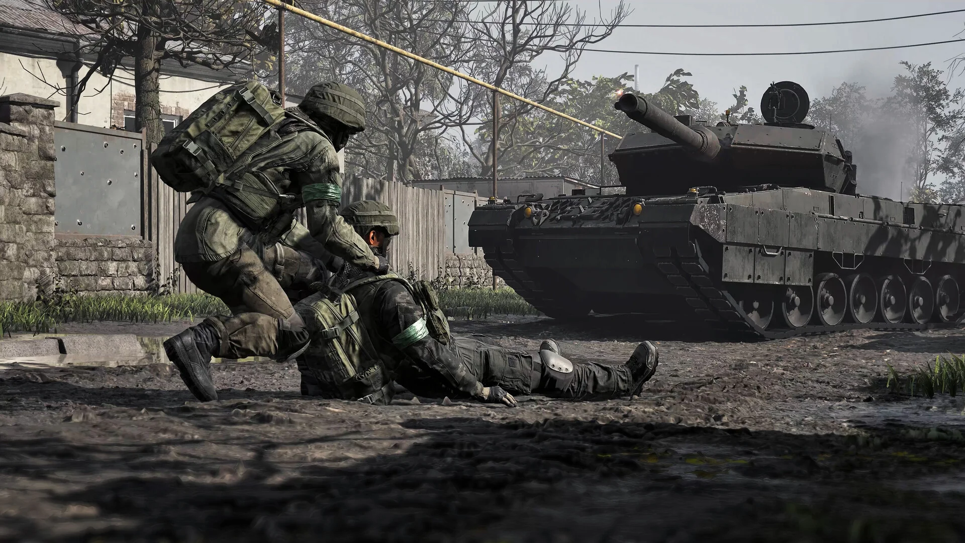 A soldier in green armbands drags a wounded teammate past a tank on a dirt village street