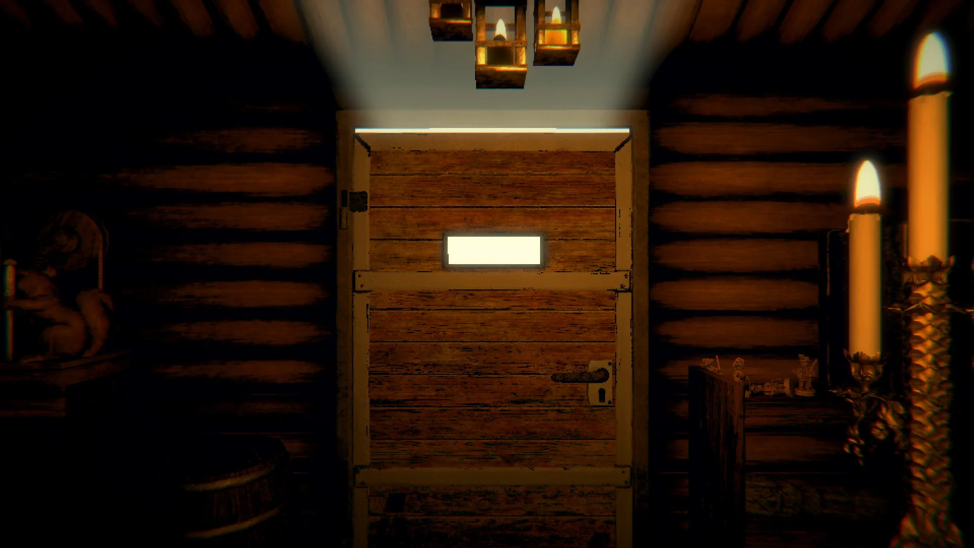 A plain wooden cabin door with a white mail slot under hanging candles