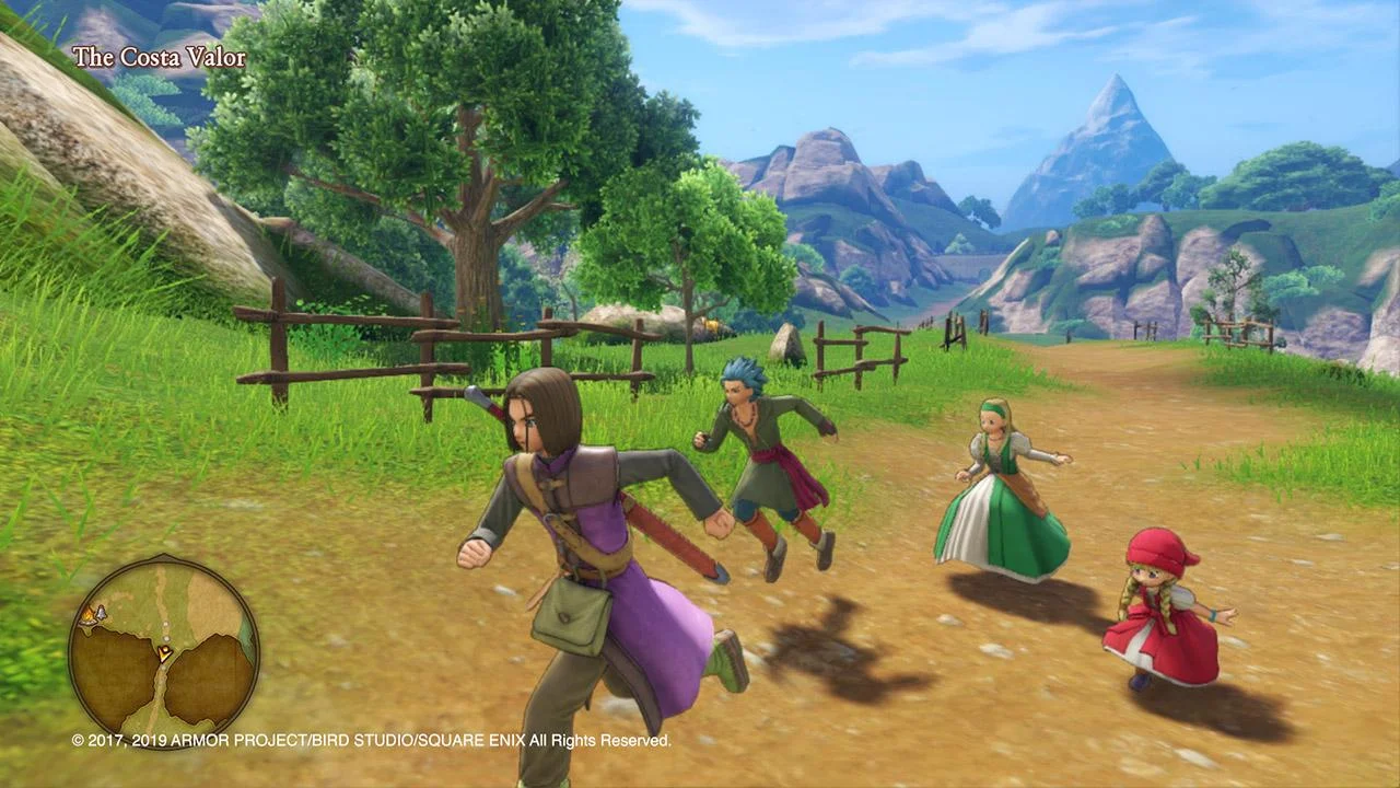 The Luminary and two companions walk a grassy path toward mountains.