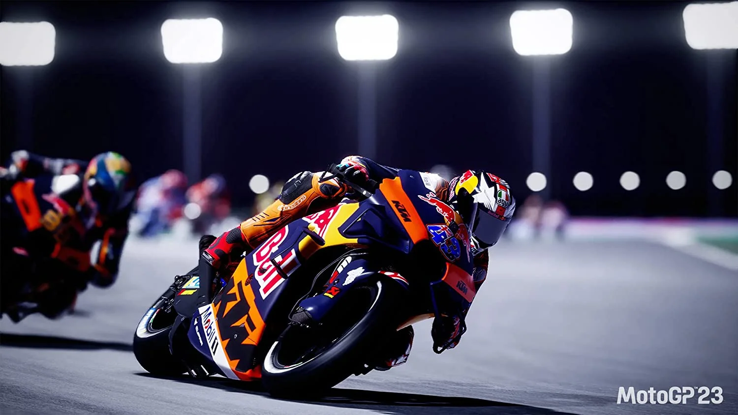 A rider leaned over on an orange and blue bike.