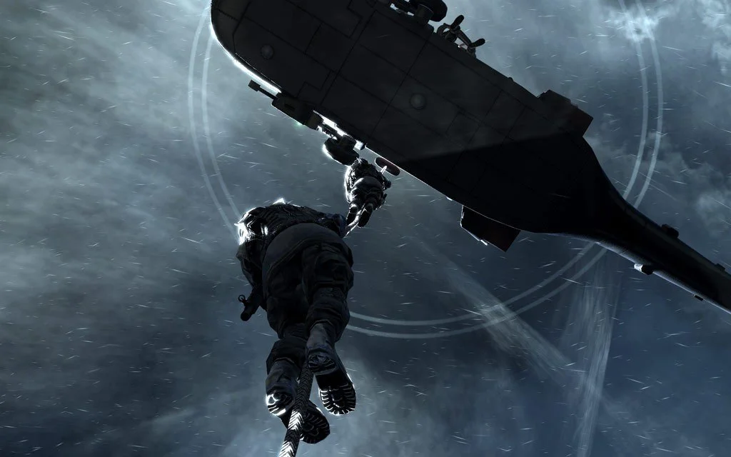 Low angle: operator hanging a fast-rope under a dark helicopter against storm clouds