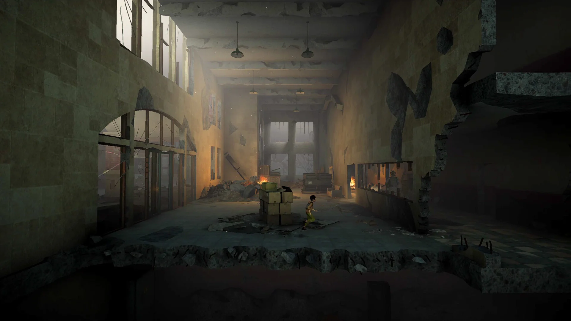 Child in a damaged two-storey hall with a broken floor, stacked boxes in the centre and hanging lamps