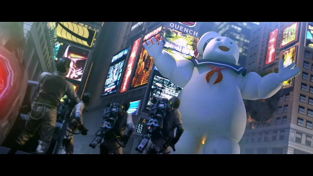 A large white ghost looms over two Ghostbusters in a dark street.